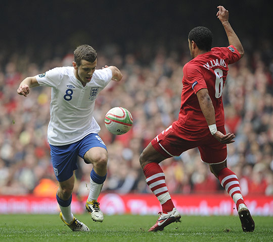 Wales v England: Jack Wilshere attempts to take the ball past Ashley Williams