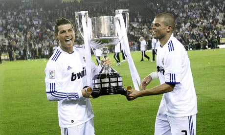 Real Madrid's Cristiano Ronaldo left and Pepe celebrate with the trophy 