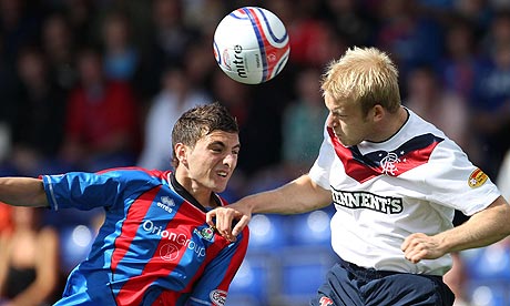 Inverness's Graeme Shinnie and Rangers Steven Naismith jump for a ball