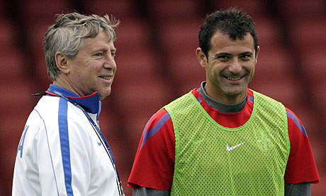 The Serbia coach Vladimir Petrovic shares a joke with Dejan Stankovic in training