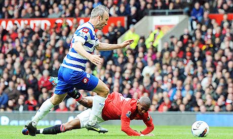 Manchester United's Ashley Young, right, tumbles after his coming together with QPR's Shaun Derry