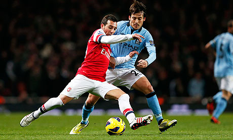 David Silva close down Santi Cazorla during Manchester City's win over Arsenal at the Emirates. 