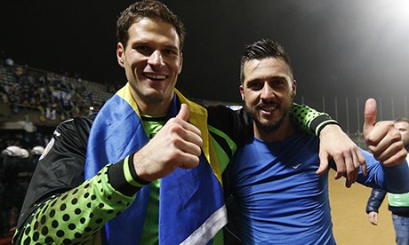 Bosnia's Asmir Begovic, left, and Haris Medunjanin celebrate their victory over Lithuania