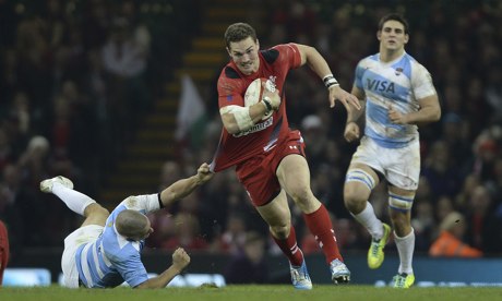 Wales wing George North attempts to escape the grasp of Argentina's Santiago Cordero in Cardiff.