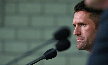 Robbie Keane tackles some pugilistic microphones before the game in Germany