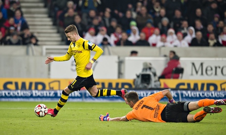 Borussia Dortmund's Marco Reus takes the ball around the Stuttgart goalkeeper Sven Ulreich to score