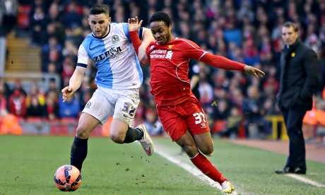 Liverpool's Raheem Sterling is held off by Craig Conway of Blackburn