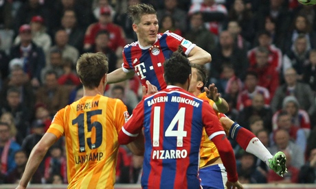 Bastian Schweinsteiger rises to score Bayern Munich's late winner against Hertha Berlin.