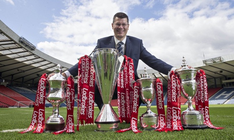 Scottish Professional Football League chief executive Neil Doncaster displays the league trophies on
