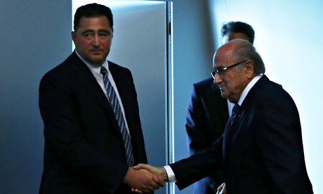 Domenico Scala, left, shakes hands with Sepp Blatter after the president announced his resignation.