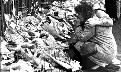 Floral tributes festoon the gates of Hillsborough the morning after the disaster.