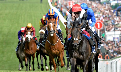Frankie Dettori and Golden Horn lead the rest of the field up the hill on Epsom Downs to win the joc