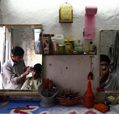 Gallery November 11 2008: Islamabad , Pakistan: A man gets a haircut at a barber shop