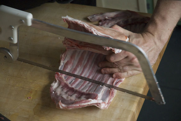 Gallery Butchering a lamb carcass: Lamb. Saw through the ribs