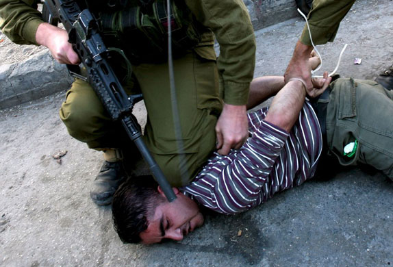 Gallery November 12 2008: Hebron, West Bank: A youth is detained after throwing stones
