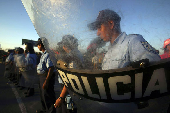 Gallery November 12 2008: Managua, Nicaragua: Police officers guard a street after clashes