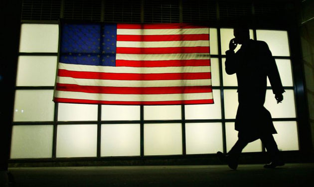 Gallery November 12 2008: New York, US: A man walks past an American flag