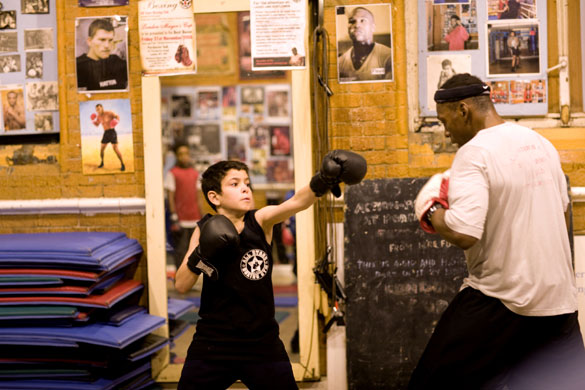 Gallery All Stars Boxing Gym: Junior Coach Tyrone Forbes with a young boxer