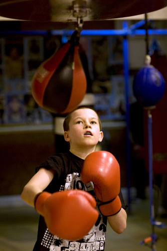 Gallery All Stars Boxing Gym: Young boxer training with a punchbag