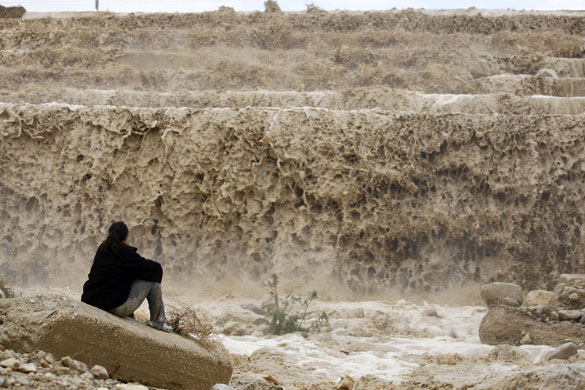 Gallery November 13 2008: Israeli woman watches flash flood  at Mitzpe Shalem