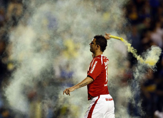 Gallery Week in sport: Marcio Rodrigues of Brazil's Internacional throws a flare