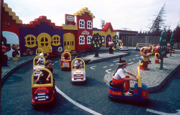 Gallery Lego: 1983: Children ride model vehicles round a miniature village in Legoland