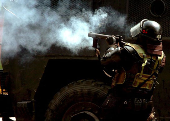 Gallery November 20 2008: Cali, Colombia: Anti-riot police clash with a group of masked protestors