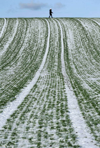 Gallery November 24 2008: Andechs, Germany: A stroller walks on a snowy hill