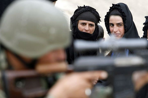 Gallery November 24 2008: Basra, Iraq: Women look at Iraqi soldiers on a patrol
