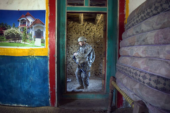 Gallery November 24 2008: Derezda Valley: A US soldier pauses in a doorway