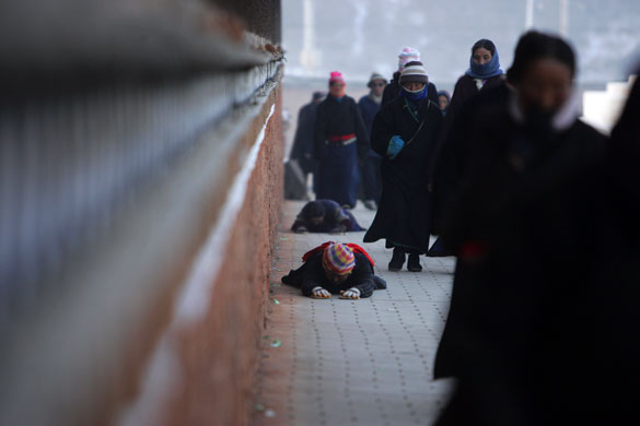 Gallery November 25 2008: Hezuo, China: Tibetan worshipers outside a monastery