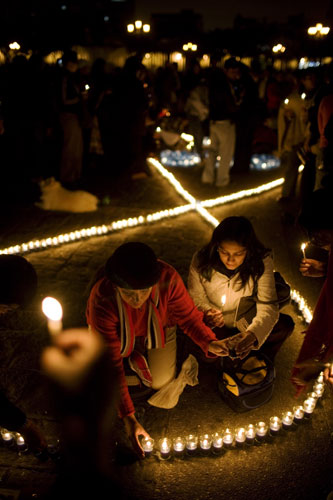 Gallery November 25 2008: Guatemala City, Guatemala: Women light candles during a ceremony