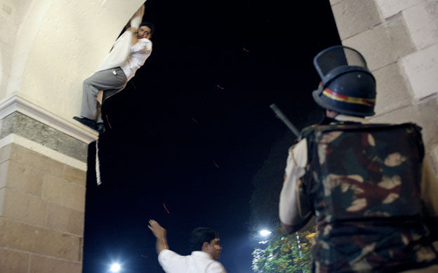 Gallery Terror attacks in Mumbai: A man uses hotel curtains to climb from the Taj Mahal hotel