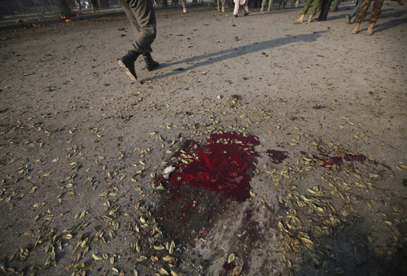 Gallery 24 hours in pictures: A policeman at the site of an explosion near the U.S. embassy in Kabul
