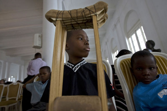 Gallery 24 hours in pictures: Students attend a ceremony for victims after collapse of a school in Haiti