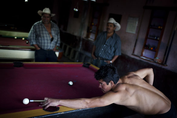 Gallery 24 hours in pictures: A man plays pool after working at 