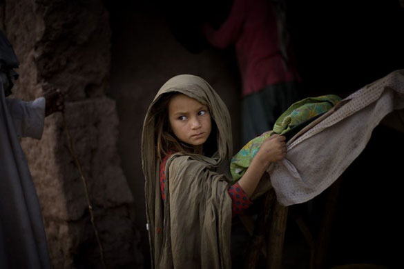 Gallery November 7 2008: A girl waits to buy bread next to the Katcha Garhi camp