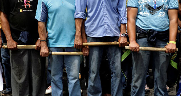 Gallery November 7 2008: Asuncion, Paraguay: Farmers hold sticks during a protest