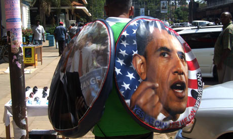 A man sells tyre covers carrying the portrait of Barack Obama in Kisumu, Kenya