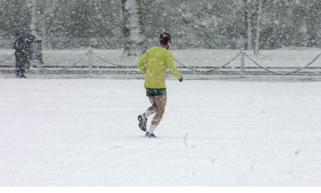 A man out jogging in a London park after a heavy snow fall in London January 2003