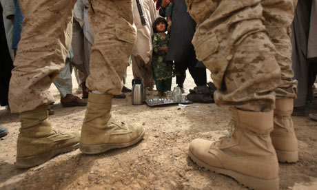 A US counter-intelligence Marine and his translator meet with local villagers in Kirta, Afghanistan Photograph: John Moore/Getty Images
