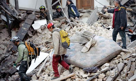 Rescuers search for trapped people after an earthquake in Aquila, Italy
