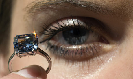 A model displays a Rare Fancy Vivid Blue Diamond during an auction preview at Sotheby's in Geneva