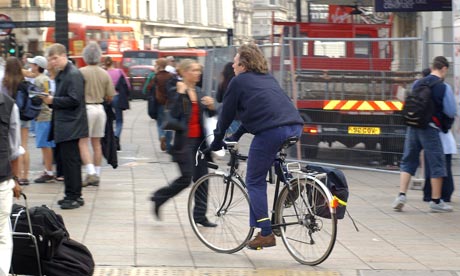Cyclist riding on the pavement in central London