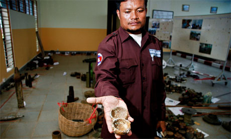 Ngoun Thy of the Cambodian Mine Action Centre holds the remnants of a cluster submunition