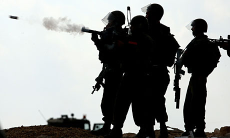 Israeli soldiers fire tear gas at protesters at a demonstration in the West Bank village of Bilin