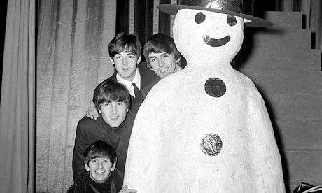 The Beatles pose with a snowman