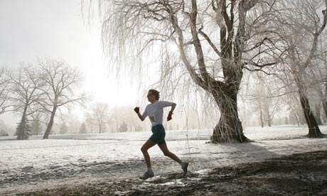 Woman jogs through park in winter