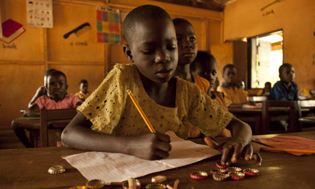 A girl uses bottle tops to count in maths lesson at Brepaw Kpeti Presby, Asesewa, Ghana