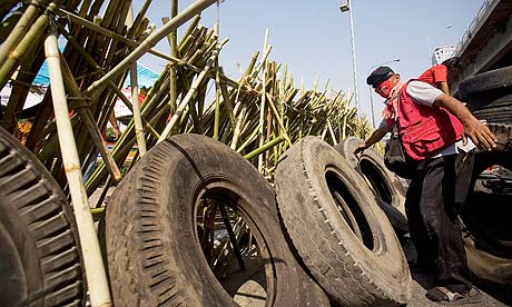 Red Shirt protesters build a barricade using bamboo poles and  tyres at an intersection in Bangkok.